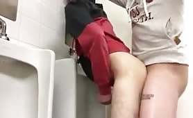 Grabbing a stranger's cock in a public toilet