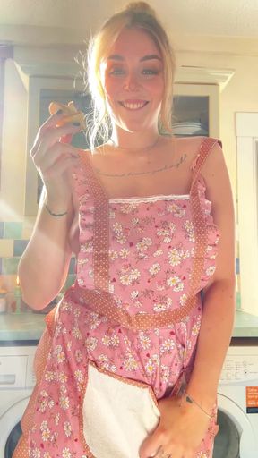 Blonde woman in apron holding food