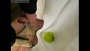 Amateur redhead guy caught pissing in a public toilet'_s urinal - he then quickly plays with his cock before leaving