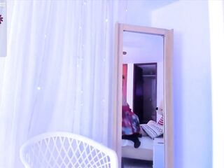 Cute faced redhead college cutie looks stunning in her skimpy lingerie while modeling on the pole