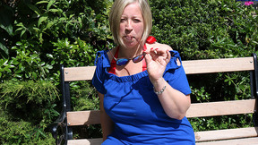 Chubby mature lady playing with her muff in the garden