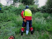Forest Worker Pup pawing off in gear and boots (outdoors)