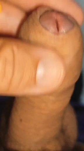 Young Straight Man Inserting the Tool Through the Glans.