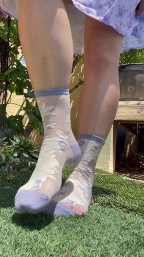Woman wearing camo socks standing on grass