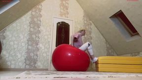 Alla happily jumps on huge black and red fitness balls