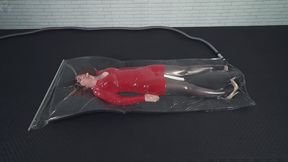 A girl in a red dress inside a thin vacuum bag on foam rubber a vibrator and an orgasm