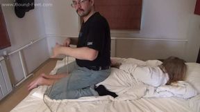Barefoot Albina Rose in bathrobe is being tied, hogtied and gagged on-screen, resisting to her captor (HD WMV)