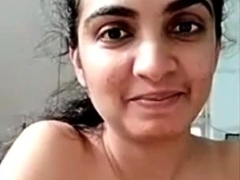 Busty indian milf strips nude to show round tits on webcam