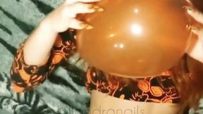 Feline nails having fun with balloons