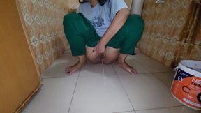 My stepsister is sitting in the bathroom and urinating.