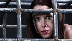 Whorish red-haired doxy gets locked in metal cage in BDSM-involved sex video