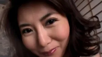 Doe eyed Asian mom gives a sensual handjob in lingerie