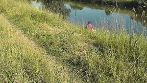 Wild MILF sunbathes naked on secluded river bank as fisherman watches and joins in