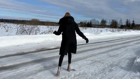 a girl in transparent high-heeled boots walks on ice and constantly slips