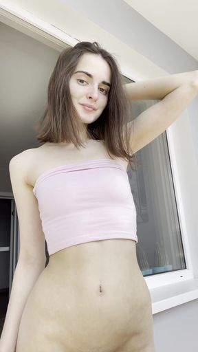 Brunette beauty flashes her bare breasts in a cute pink tube top