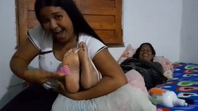 Lalita tickles Rebeca's feet