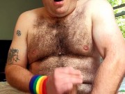 Hairy tattooed guy jerks off big cock, fingers tight little asshole, cums on chest, eats cum