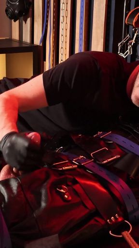 Edging the Boy in Leather Bondage but He Is Not Allowed to Orgasm