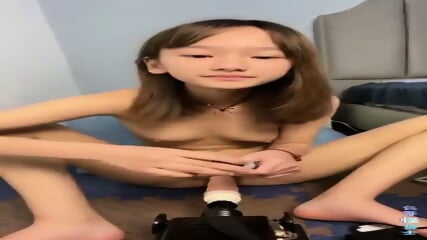 Beautiful girl fucking using a dildo machine