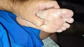 Giving her a soft foot rub and massage on the couch