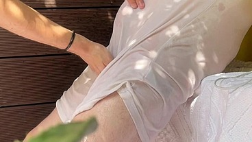 A boy has fun watering his friend's white t-shirt and exposing his smooth ass and big uncut cock