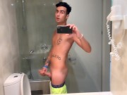 Quick hotel bathroom cumshot into sink in swim trunks while friend is gone