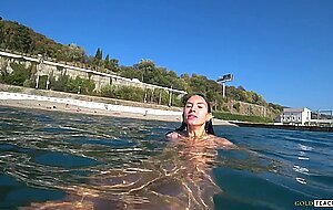 Goldteachers, naked model swims on a public beach in ru