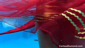 Carissa struggles, wrestles, and then embraces the long air hose in the pool