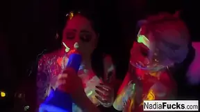 Ophelia Rain And Nadia White In Black-light Darlings Suck Off Colorful Cock