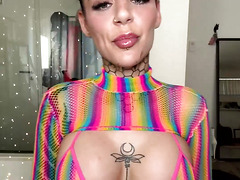 Inked Hottie with Buns Teases in Shiny Rainbow Mesh Top