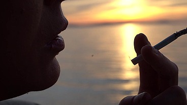 Smoking Cigarettes on the Beach... at day and in Sunset