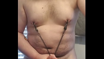 Fatty rubbing his cock playing with nipple clamps