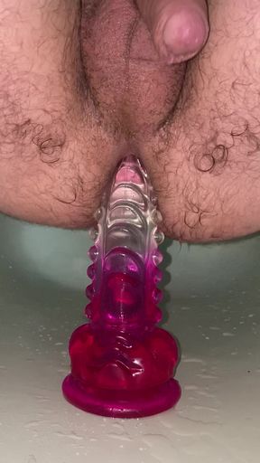 Jumping on a big dildo