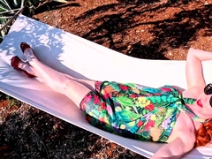 Red XXX stuffs her pussy with a toy in the hammock