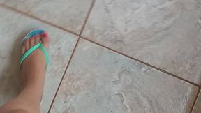 small, delicate feet walking with flip-flops.