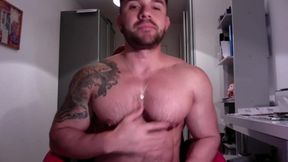 Tattooed Muscled Man Communicates with His Viewer