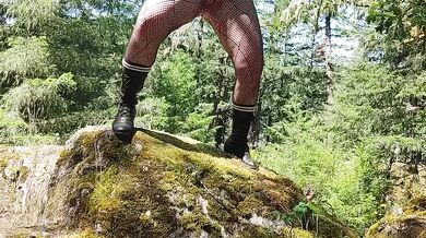 Blue haired milf gushes deep in the forest while whacking it on the tree