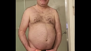 Nude Martin Lavall&eacute_e sodomizes himself with a large dildo in a black cage