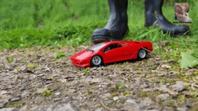 Red metal Car under black Wellies