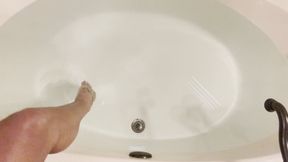 Cariss in the sheer bodysuit in the bathtub with the metal tickler sensual touch