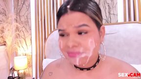 chubby chick with fake cum on her face sucks a big dildo