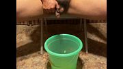 Taking a seated naked desperate piss inside a bucket in the living room