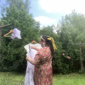 In vintage floral pattern dress for a day hanging laundry