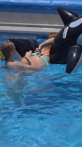 Lesbian Girls Are Having Fun in a Pool with an Inflatable Shark