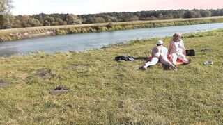 Wild beach. Nudist beach. Outdoor on bank of river girlfriend