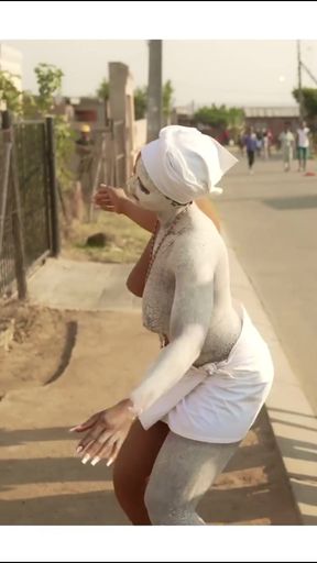 Covered in body paint, dancing on street