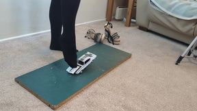 Giantess Lily Kink toy car crush of a 1969 Oldsmobile Hurst in Nylons then in big mega wedges high left view