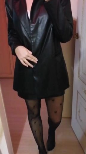 The girl shows what she is wearing under her leather dress
