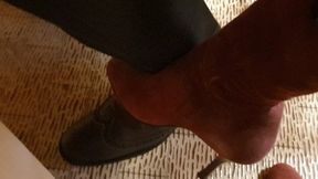 Teasing in red suede boots under the table