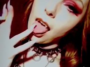 Goth stripper with fangs smoking